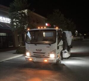 Metrowest sweeping truck removing dirt and debris from parking lots